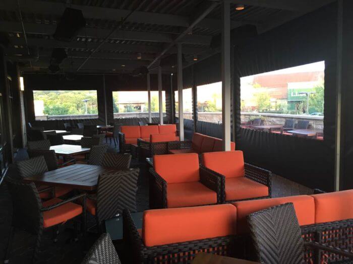 motorized clear vinyl and sun shade enclosures outside restaurant patio orange booths shaded